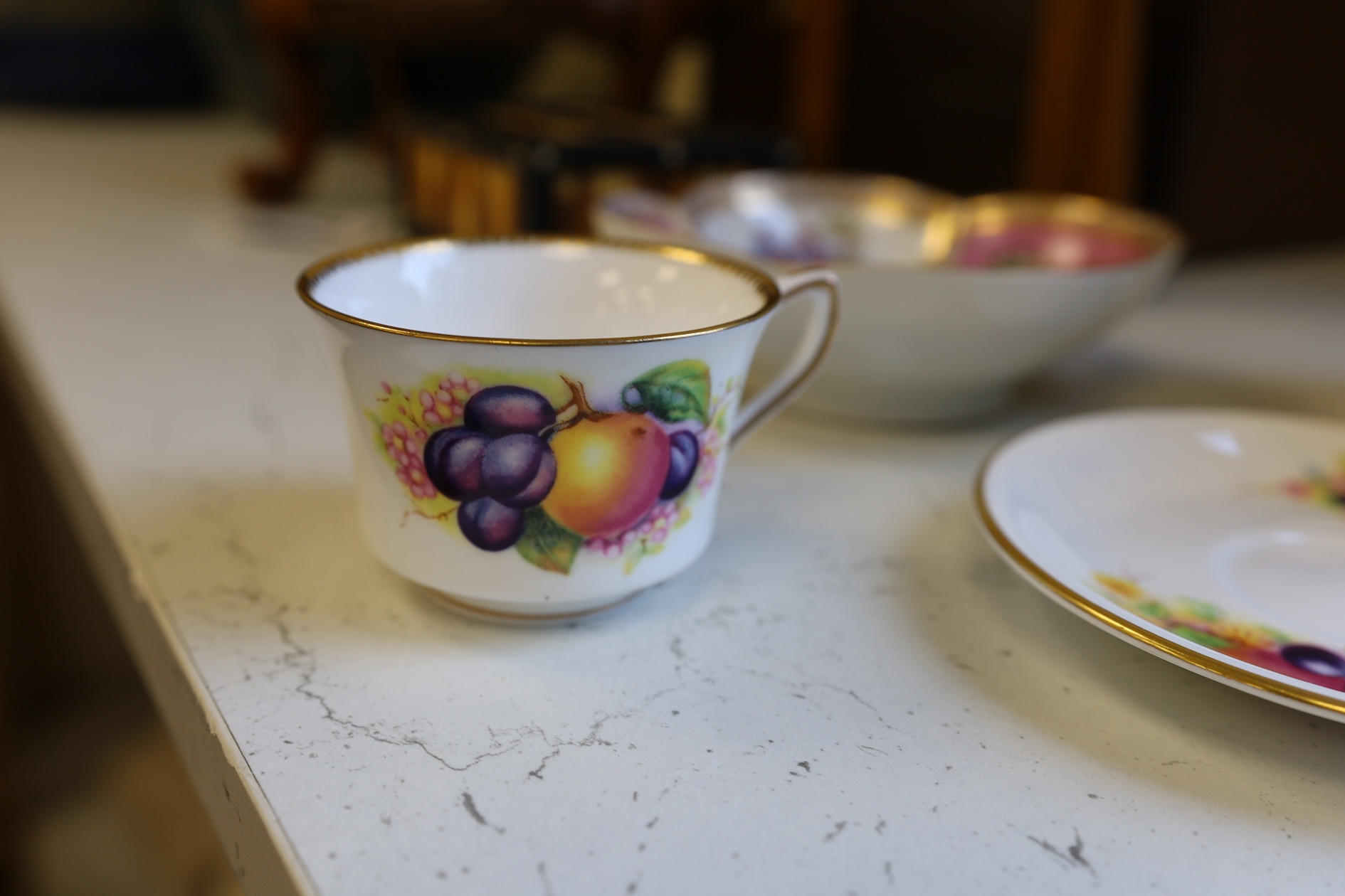 A Wedgwood three colour biscuit barrel with plated rim and handle, a Royal Worcester cup and saucer and a Dresden shaped bowl, biscuit barrel 17cm high. Condition - good